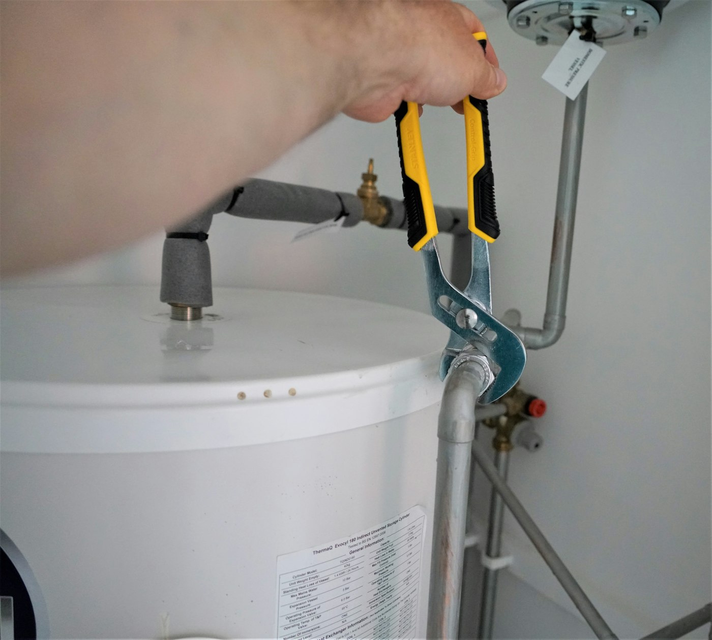 Plumber fitting a hot water system